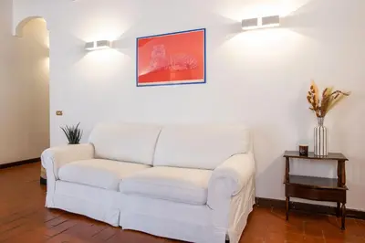 a living room with a white couch and a table at Barchetta Loft in Rome