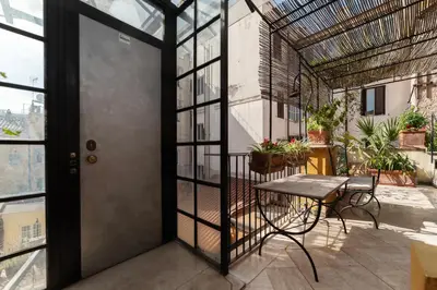 an open door to a balcony with a table and chairs at White Room with bathroom and Shared Terrace in Rome