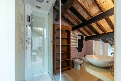 a bathroom with a large tub and a toilet at White Room with bathroom and Shared Terrace in Rome