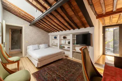 a bedroom with a bed and a flat screen tv at White Room with bathroom and Shared Terrace in Rome