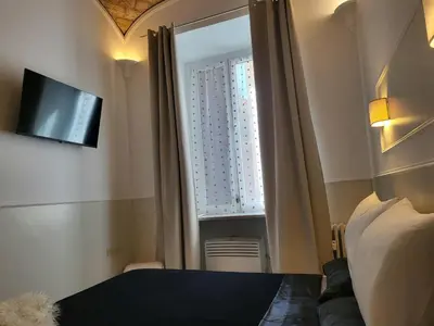 a bedroom with a bed and a window with a television at Monteoppio one in Rome