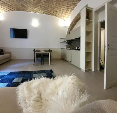 a living room with a table and a white rug at Monteoppio one in Rome