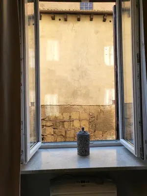a window with a vase sitting on a window sill at Monteoppio one in Rome