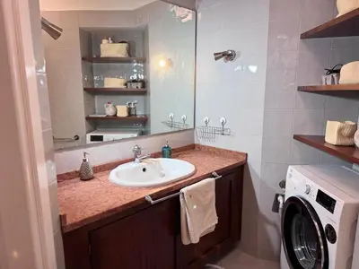 a bathroom with a sink and a washing machine at Sanniti House in Rome