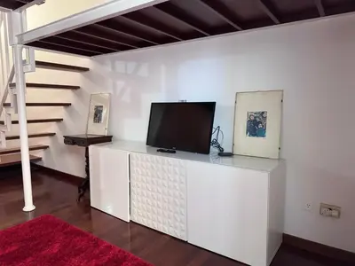 a living room with a tv on a white cabinet at Sanniti House in Rome