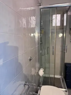 a bathroom with a shower and a toilet in it at Sanniti House in Rome