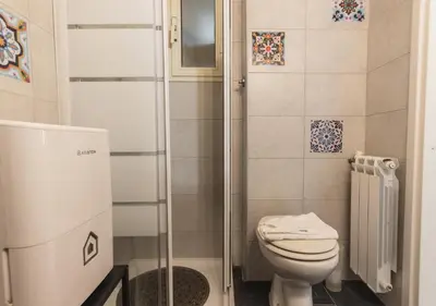a small bathroom with a toilet and a shower at Delizioso loft vicino Piazza del Popolo in Rome