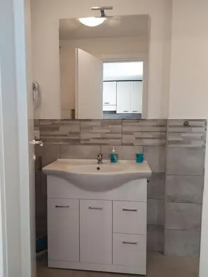 a bathroom with a white sink and a mirror at casetta romana in Rome