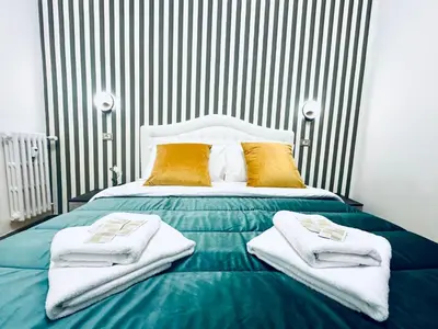 a bedroom with a bed with towels on it at Rome Termini Down-town Accommodation in Rome