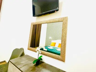 a mirror on a wall with a bed in a bedroom at Rome Termini Down-town Accommodation in Rome