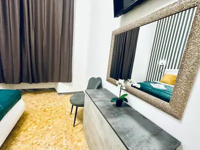 a bedroom with a mirror and a table and a bed at Rome Termini Down-town Accommodation in Rome