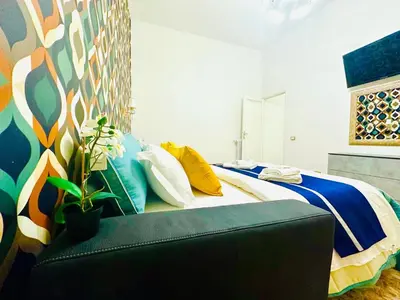a bedroom with a large bed with a couch at Rome Termini Down-town Accommodation in Rome