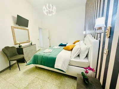 a bedroom with a bed and a desk and a chair at Rome Termini Down-town Accommodation in Rome