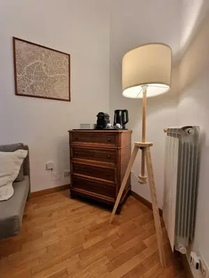 a room with a lamp and a dresser and a radiator at Casa Claudia in Rome