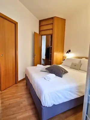 a bedroom with a large white bed in a room at Casa Claudia in Rome