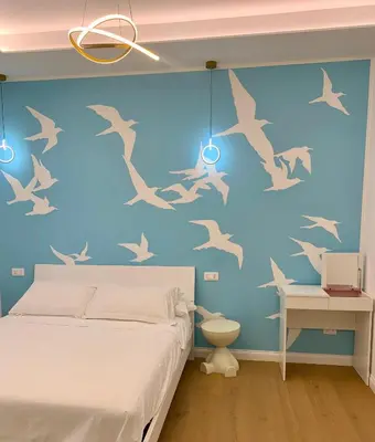 a bedroom with birds painted on the wall at Roma Tiburtina - Elementcity Suites in Rome