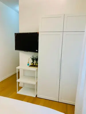 a white cabinet with a television on top of it at Roma Tiburtina - Elementcity Suites in Rome