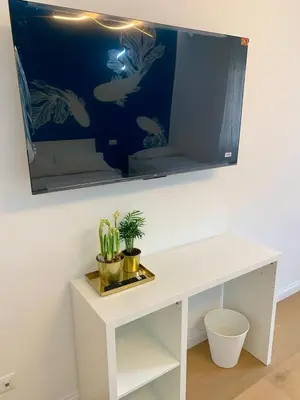a white desk with a fish tank on the wall at Roma Tiburtina - Elementcity Suites in Rome