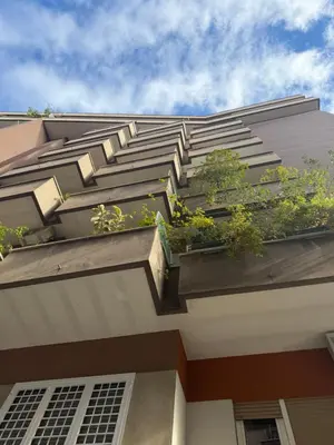 a building with potted plants on the side of it at Roma Tiburtina - Elementcity Suites in Rome