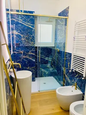 a bathroom with a glass shower and a sink at Roma Tiburtina - Elementcity Suites in Rome
