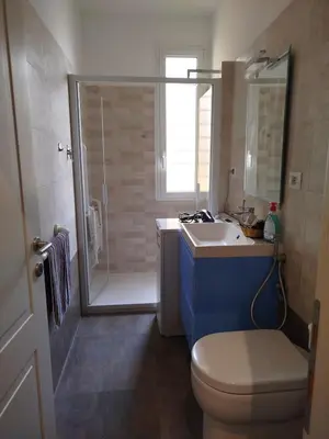 a bathroom with a toilet and a sink and a shower at Hub in R'home in Rome