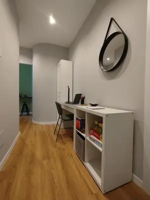 an office with a desk and a mirror on the wall at Hub in R'home in Rome