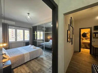 a bedroom with a bed and a mirror at Relax & Explore Stylish Apartment in Rome in Rome