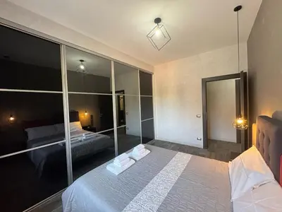a bedroom with a bed and a large mirror at Relax & Explore Stylish Apartment in Rome in Rome