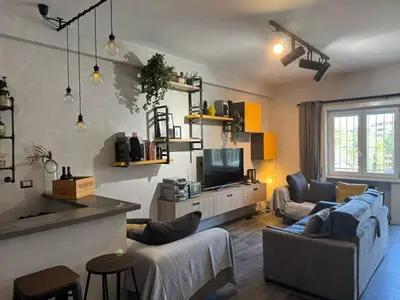 a living room with two couches and a television at Relax & Explore Stylish Apartment in Rome in Rome