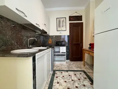 a kitchen with a sink and a refrigerator at Big bright Flat - Vatican Foro Italico in Rome