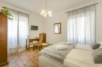 a bedroom with a bed and a desk in it at BB Trastevere Station - Room1 in Rome
