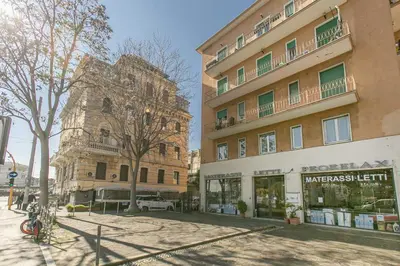 a building on a street next to a building at BB Trastevere Station - Room1 in Rome