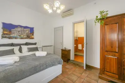 a bedroom with a large bed and a bathroom at BB Trastevere Station - Room1 in Rome