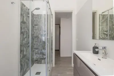 a bathroom with a shower with a sink and a mirror at Domus Ponte Lungo in Rome