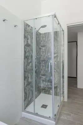 a glass elevator in a room with a wall at Domus Ponte Lungo in Rome