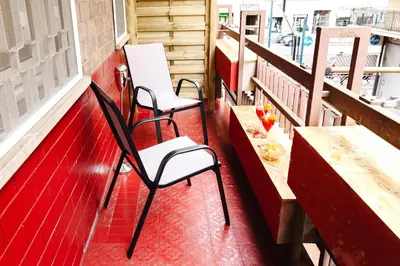 a balcony with two chairs and a table and benches at Gioele's Apartment in Rome