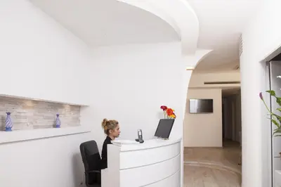 a man sitting at a desk with a computer at Maison Maneli in Rome
