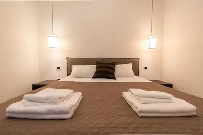 a bedroom with a bed with two towels on it at Maison Maneli in Rome