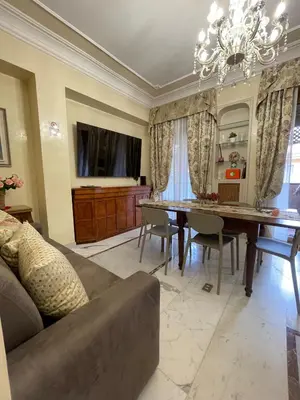 a living room with a table and a couch at Family Suite Santamaria in Rome