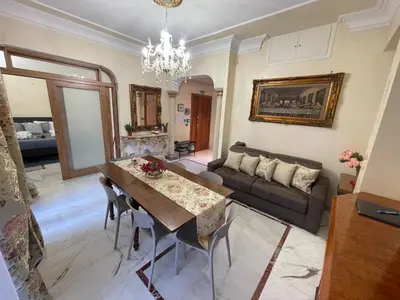 a living room with a table and a couch at Family Suite Santamaria in Rome