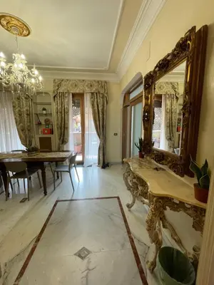 a dining room with a mirror and a table at Family Suite Santamaria in Rome