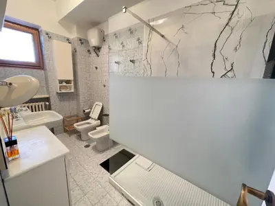 a bathroom with a toilet and a sink at Family Suite Santamaria in Rome