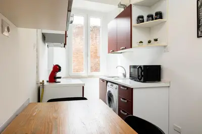 a small kitchen with a table and a microwave at Fernando’s Apartment in Rome