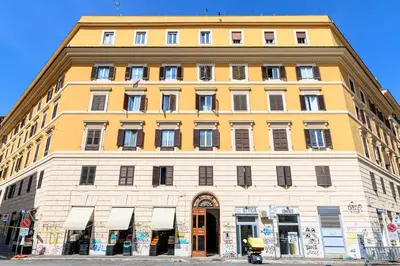 a large yellow and white building on a street at Sanniti Luigi Cozy Home in Rome
