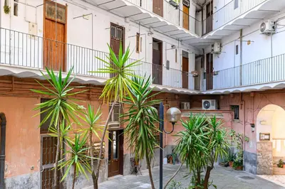 a row of palm trees in front of a building at Sanniti Luigi Cozy Home in Rome