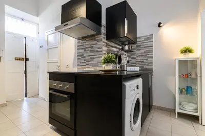 a kitchen with a washer and dryer in it at Sanniti Luigi Cozy Home in Rome