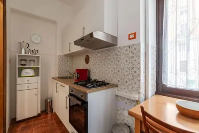 a small kitchen with a stove and a sink at GuestHost - Bright Apartment X4 along the Tevere! in Rome