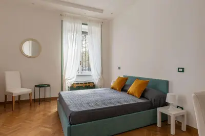 a bedroom with a green bed and a window at GuestHost - Bright Apartment X4 along the Tevere! in Rome