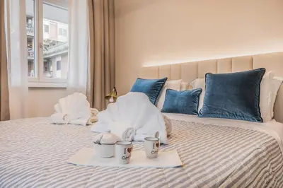 a bed with two towels and two cups on it at EP2000 Roman Holidays in Rome