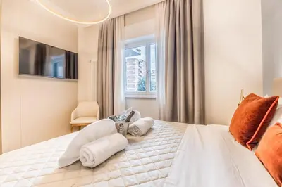 a bedroom with a white bed with towels on it at EP2000 Roman Holidays in Rome